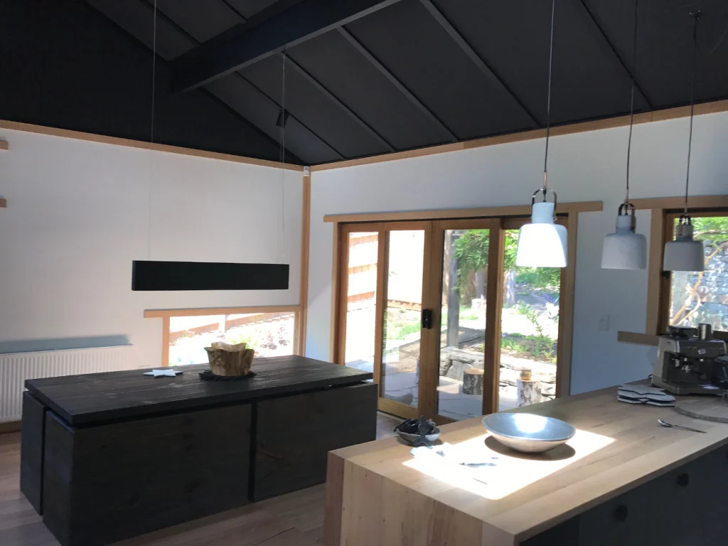 Kitchen under a dark raked ceiling